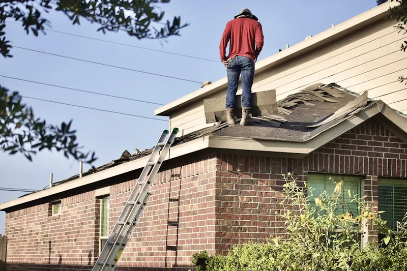 Professional roofer working on a residential roof in Pitman